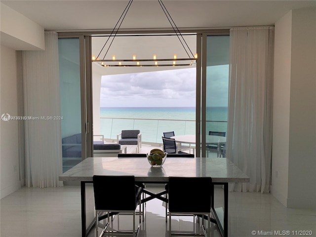 16901 Collins Ave Unit 1402, Sunny Isles Beach, FL 33160 - dining room featuring a wall of windows, a water view, and a chandelier