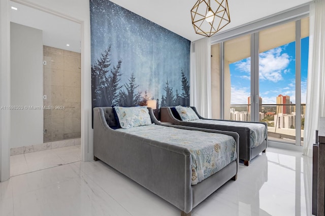 bedroom featuring connected bathroom and a chandelier