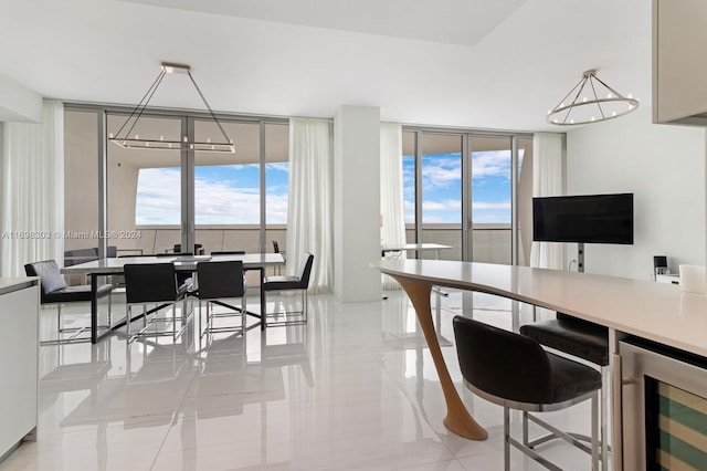 16901 Collins Ave Unit 1402, Sunny Isles Beach, FL 33160 - dining room featuring a chandelier, a wall of windows, beverage cooler, and light tile patterned flooring