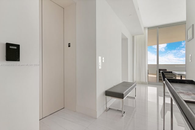 16901 Collins Ave Unit 1402, Sunny Isles Beach, FL 33160 - corridor featuring floor to ceiling windows and tile patterned flooring