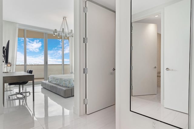 16901 Collins Ave Unit 1402, Sunny Isles Beach, FL 33160 - bedroom with a chandelier, a wall of windows, and light tile patterned floors