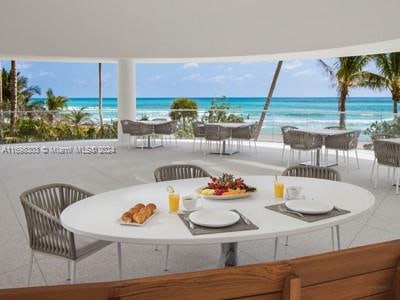 dining room featuring a view of the beach and a water view