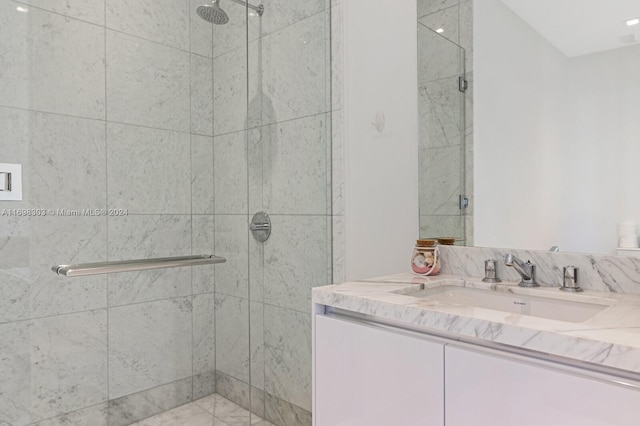 bathroom featuring vanity and a shower with shower door