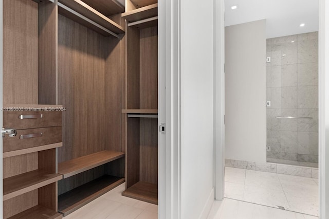 spacious closet with light tile patterned floors