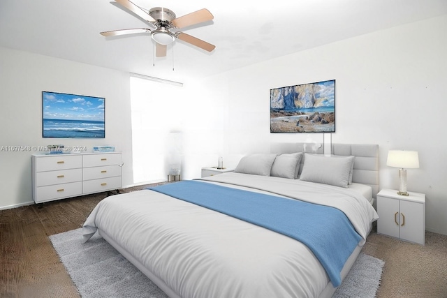 bedroom with dark hardwood / wood-style flooring and ceiling fan