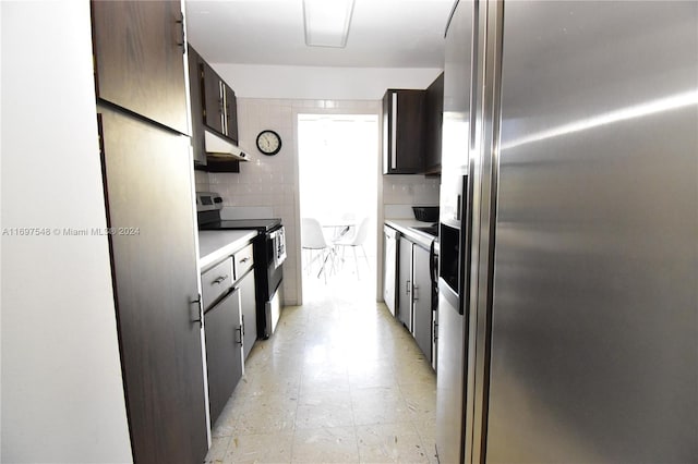 kitchen featuring tile walls and appliances with stainless steel finishes