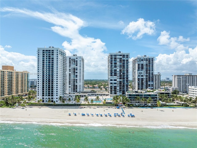 drone / aerial view featuring a water view and a view of the beach