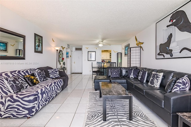 tiled living room featuring a textured ceiling and ceiling fan