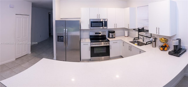 kitchen with white cabinets, light countertops, and appliances with stainless steel finishes