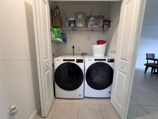 washroom featuring washer and clothes dryer and light tile patterned floors