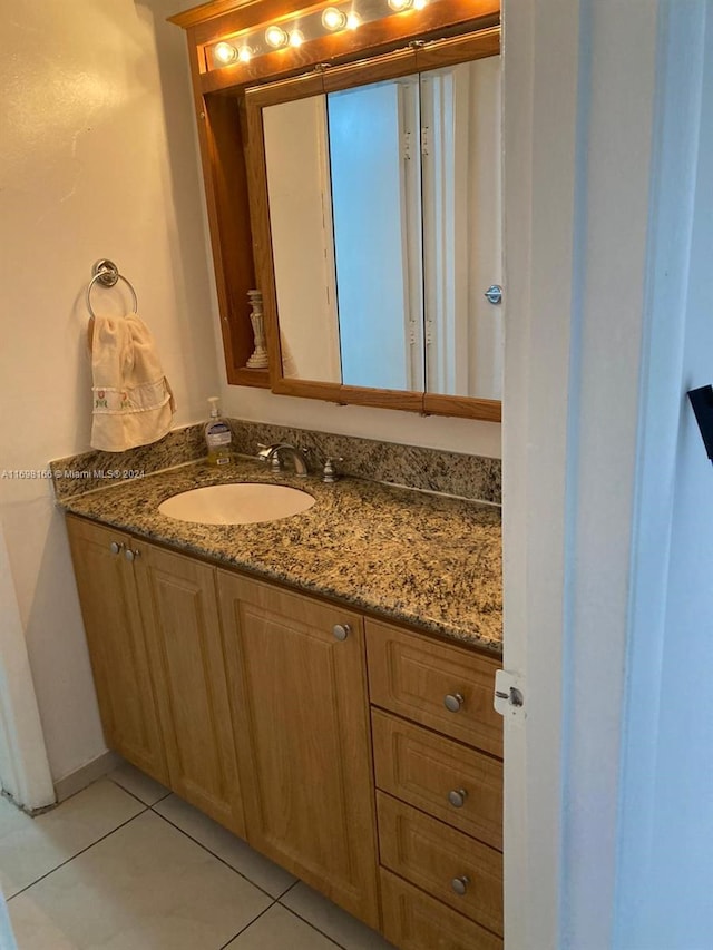 bathroom with tile patterned floors and vanity