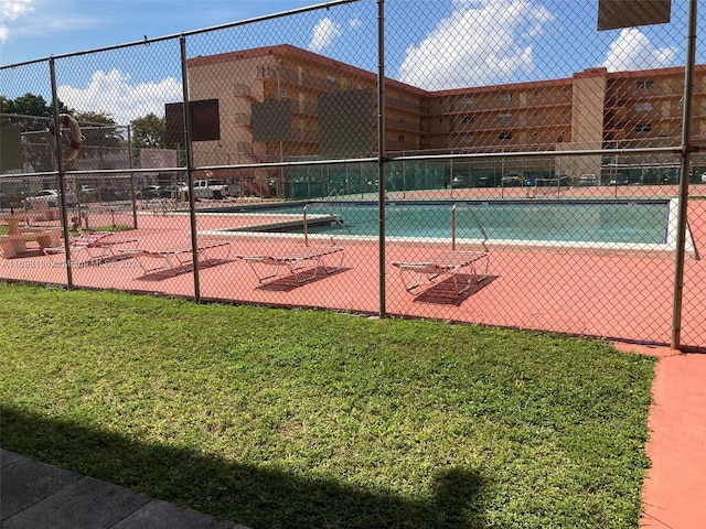 view of pool featuring a yard