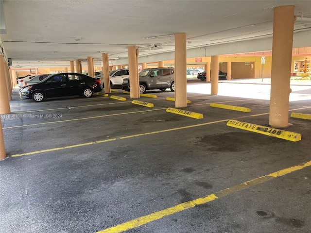 garage with a garage door opener and a carport