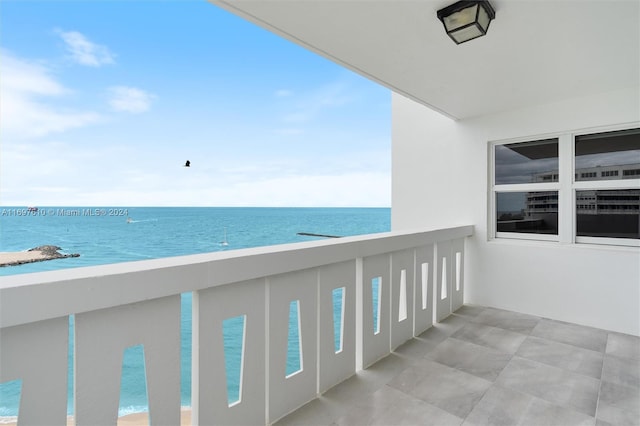 balcony featuring a water view and a view of the beach