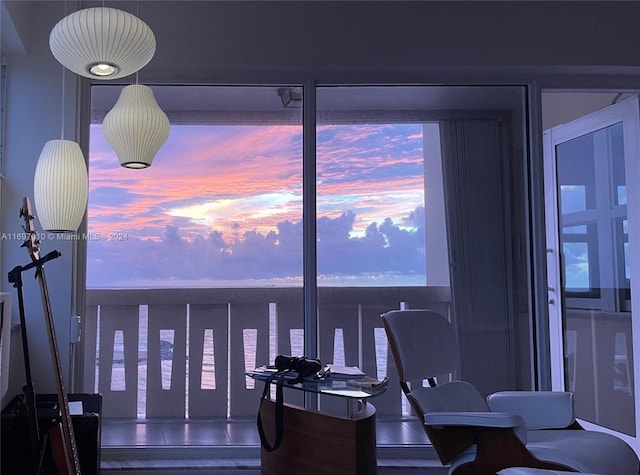 dining area featuring a water view and wood-type flooring