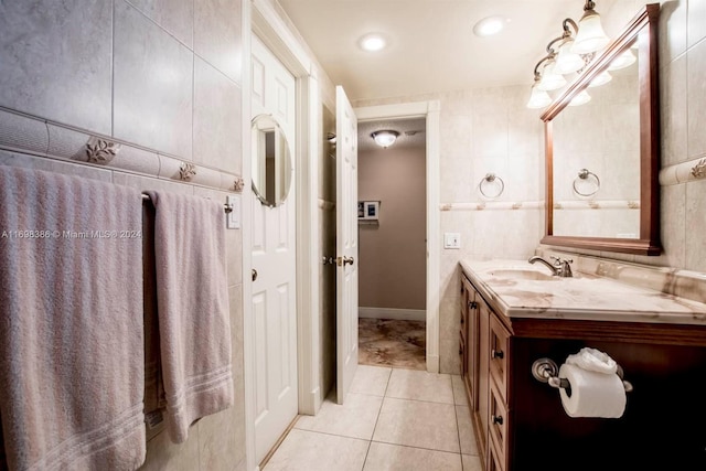 bathroom featuring tile patterned flooring, vanity, and tile walls