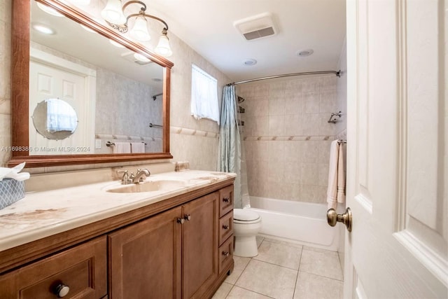 full bathroom with tile patterned flooring, vanity, shower / bath combo, and toilet