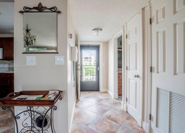 entrance foyer featuring light tile patterned floors and a textured ceiling