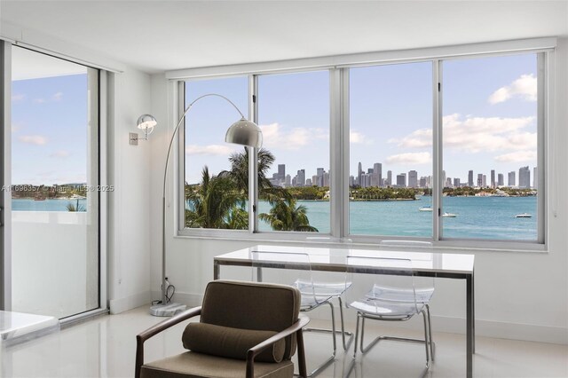 sunroom / solarium featuring a water view