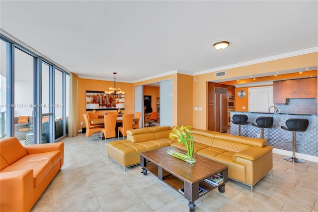 tiled living room with sink, crown molding, and a chandelier