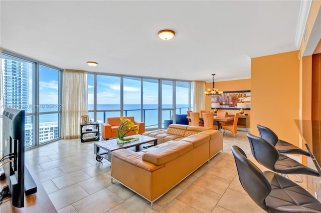 living room with expansive windows, a water view, ornamental molding, light tile patterned floors, and a chandelier