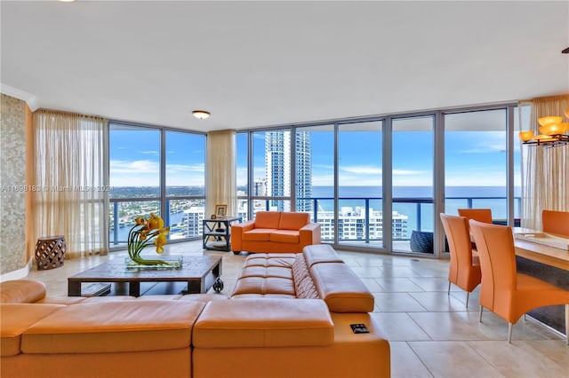 living room featuring expansive windows, a water view, light tile patterned floors, and a chandelier