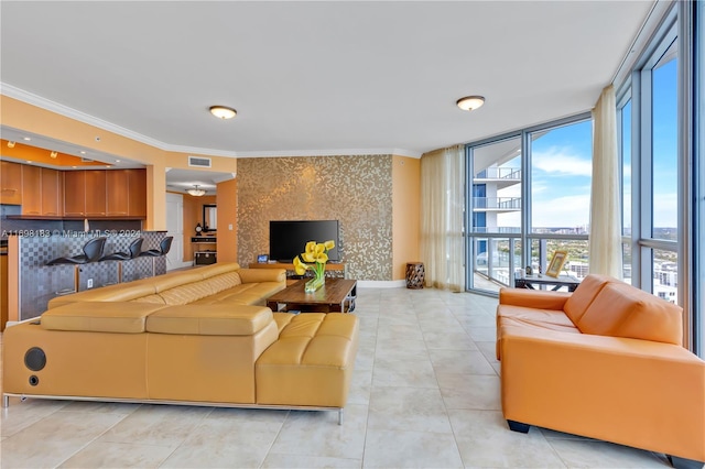 living room with light tile patterned floors, a wall of windows, and ornamental molding