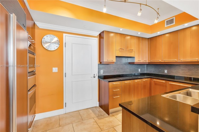 kitchen featuring hanging light fixtures, decorative backsplash, light tile patterned floors, ornamental molding, and stainless steel appliances