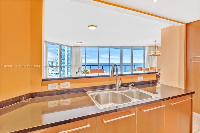 kitchen featuring a water view and sink