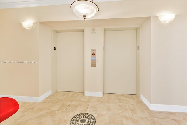 interior space featuring light tile patterned floors and elevator