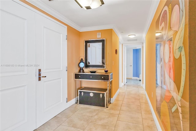 corridor with crown molding and light tile patterned floors