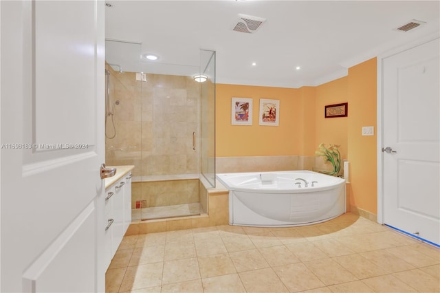 bathroom featuring plus walk in shower, tile patterned flooring, and vanity