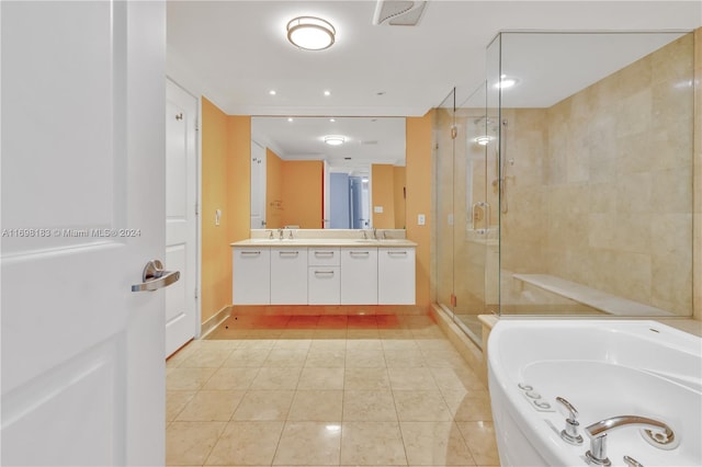 bathroom with tile patterned flooring, vanity, and plus walk in shower