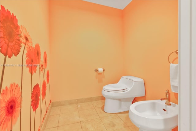 bathroom with tile patterned floors, toilet, and a bidet