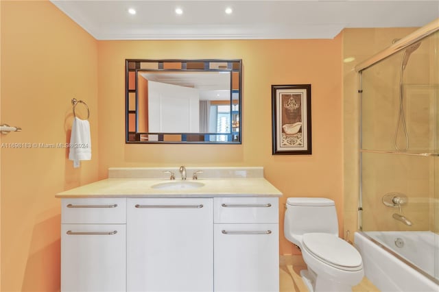 full bathroom featuring combined bath / shower with glass door, tile patterned floors, toilet, vanity, and ornamental molding