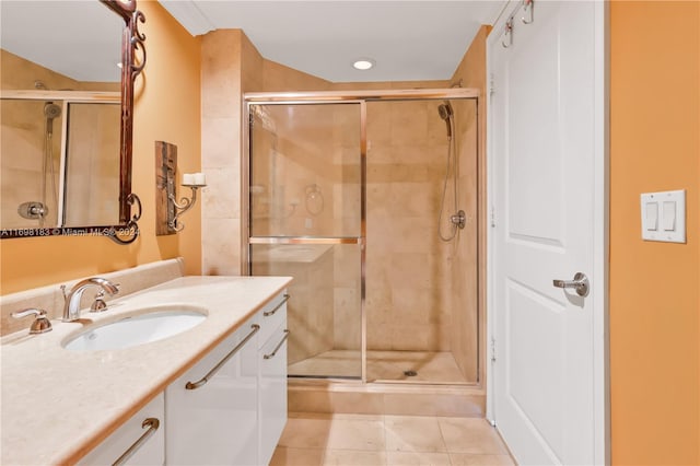 bathroom with tile patterned flooring, vanity, and a shower with door