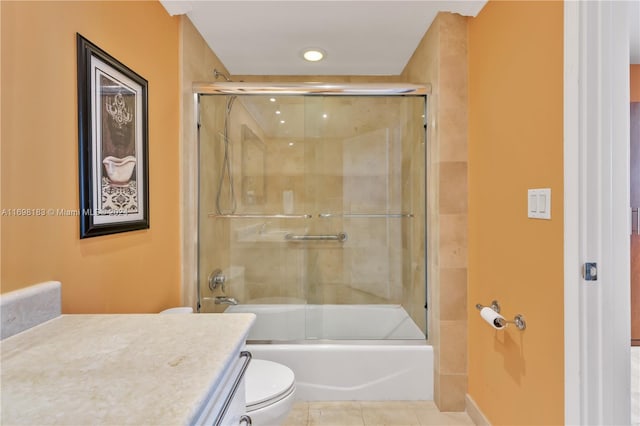 full bathroom with tile patterned flooring, toilet, combined bath / shower with glass door, and vanity