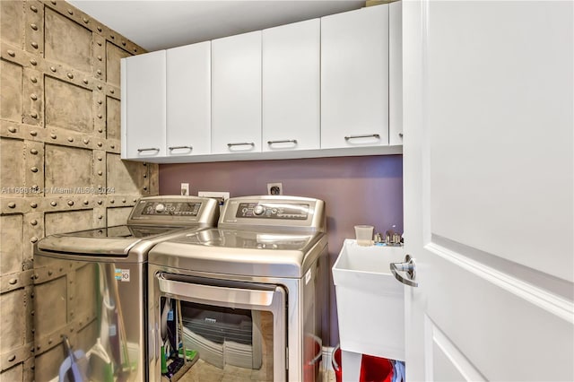 clothes washing area featuring cabinets, separate washer and dryer, and sink