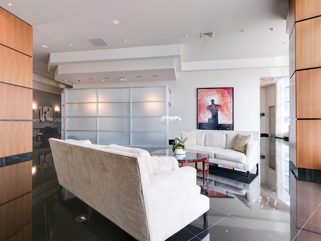 living room with dark tile patterned flooring