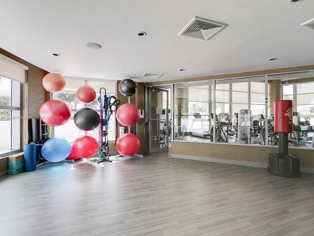 exercise room with light wood-type flooring