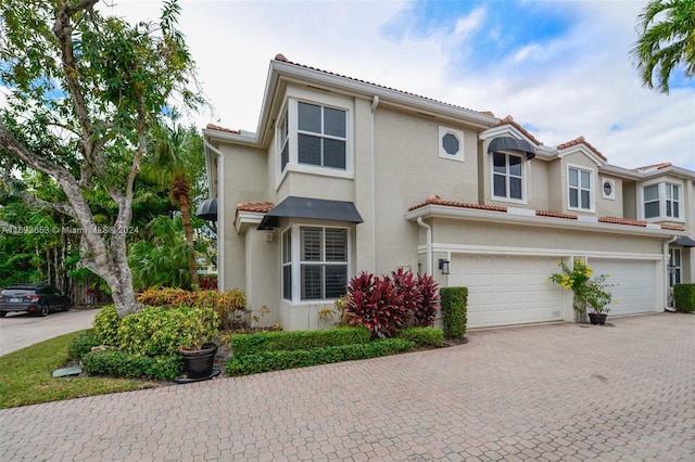 mediterranean / spanish-style home featuring a garage