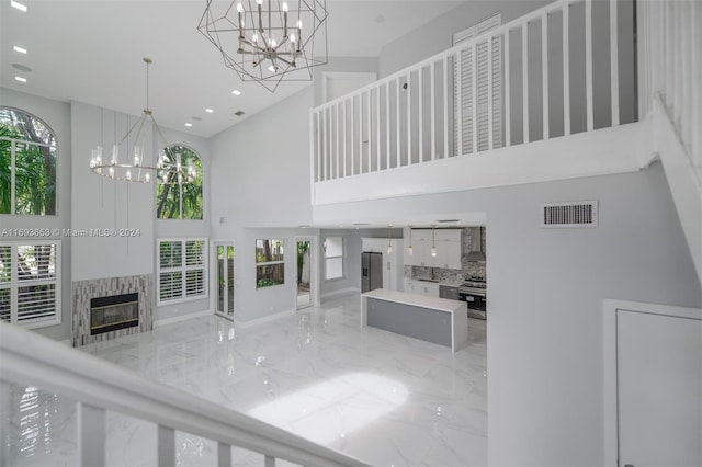 unfurnished living room with a towering ceiling