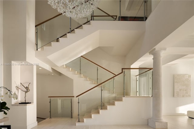 stairs with a towering ceiling and ornate columns