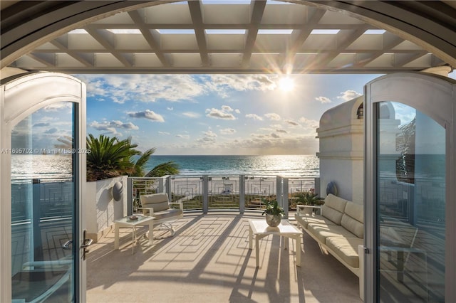 balcony featuring a water view and outdoor lounge area