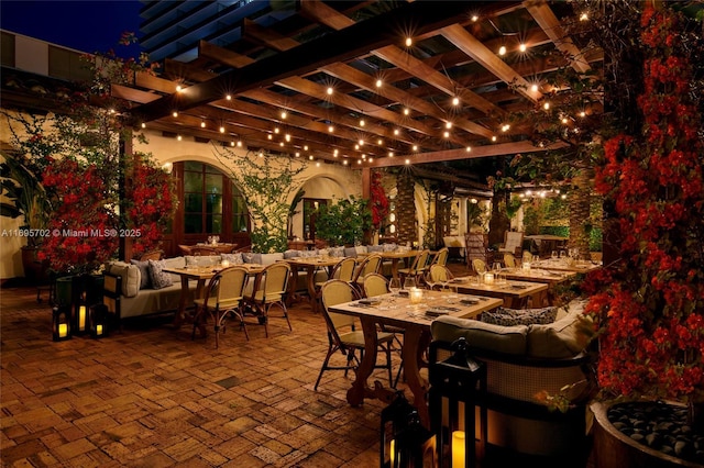 patio at night featuring a pergola