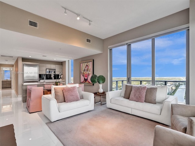 tiled living room with a water view