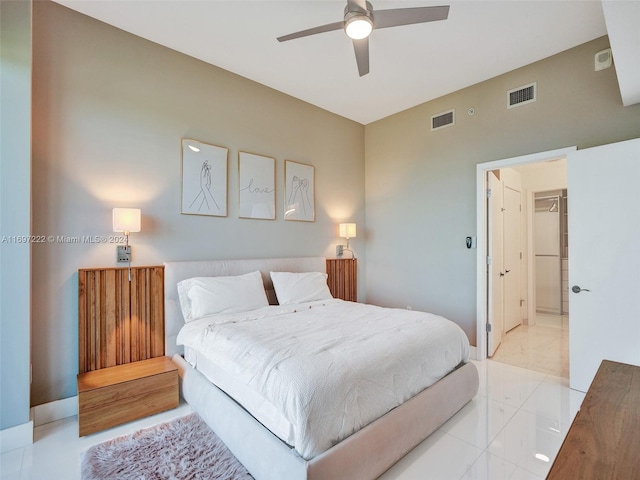 bedroom featuring a spacious closet, a closet, and ceiling fan