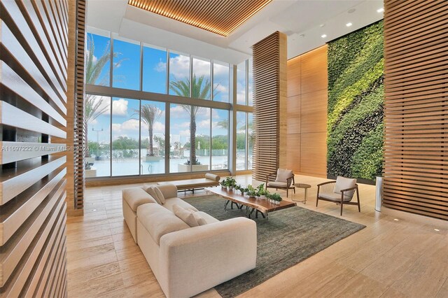 16385 Biscayne Blvd Unit 3201/Lph01, North Miami Beach, FL 33160 - living area featuring a high ceiling, a wall of windows, a water view, recessed lighting, and wood finished floors
