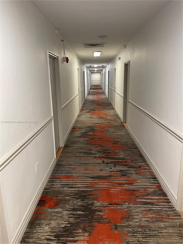 corridor with dark hardwood / wood-style floors