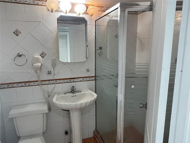 bathroom featuring walk in shower, toilet, and tile walls